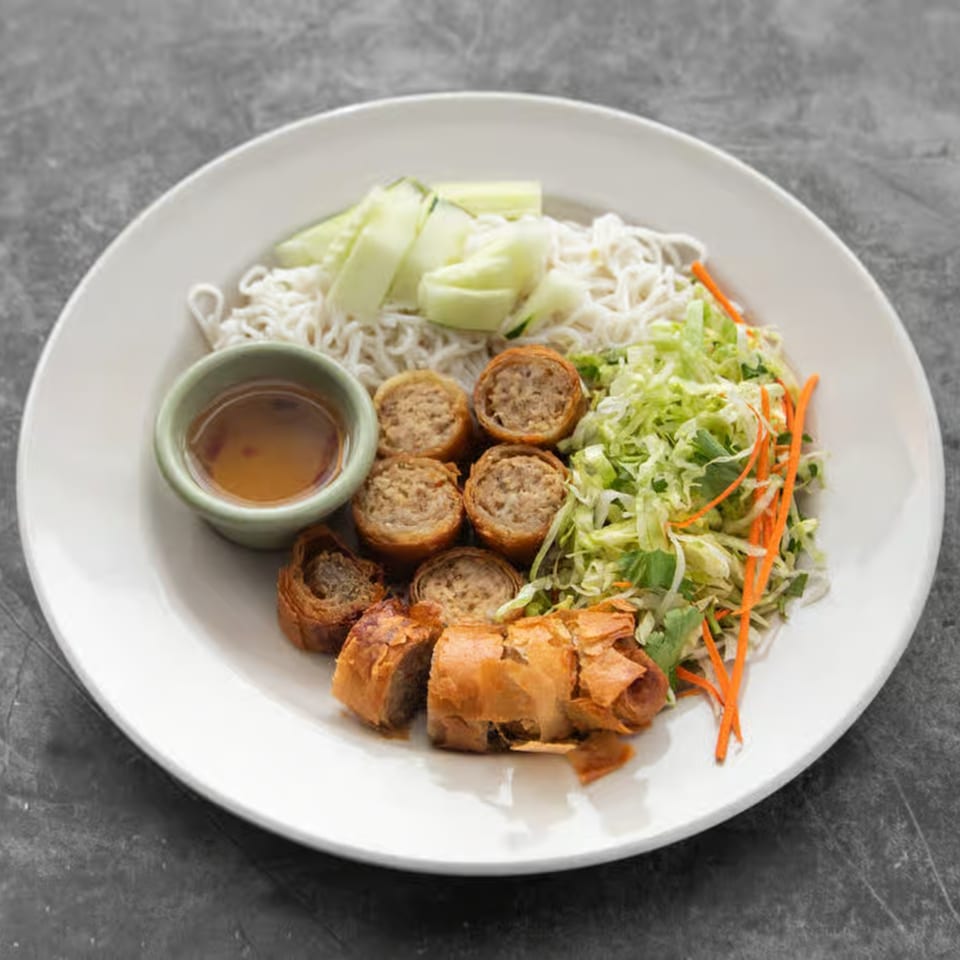 Mai Thai Restaurant's crispy spring rolls, vermicelli noodles, fresh cucumber, and shredded lettuce with sauce.